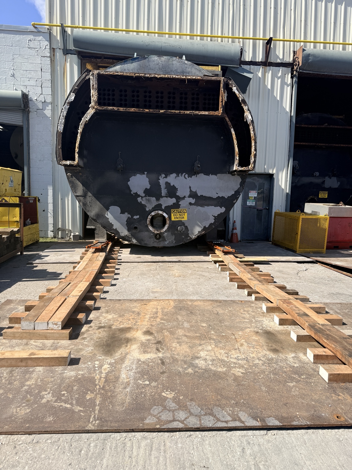 Industrial boiler positioned on skates during removal