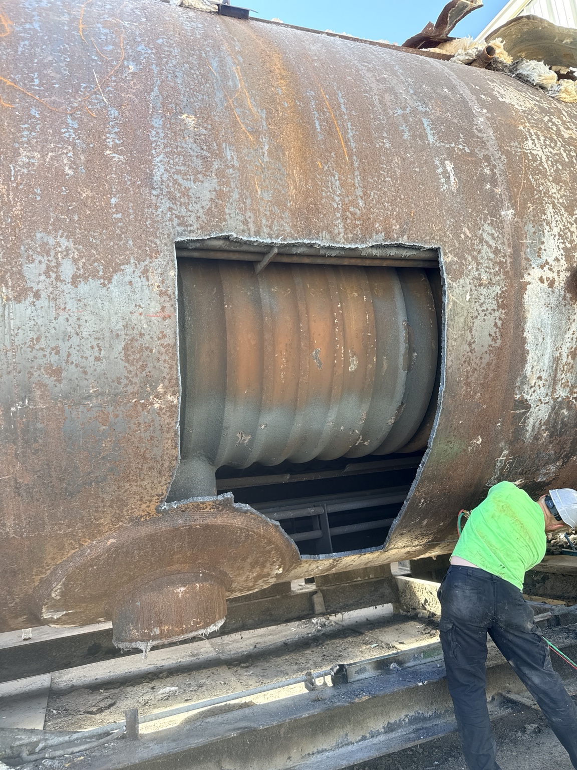 On-site torch work preparing industrial boiler equipment for removal