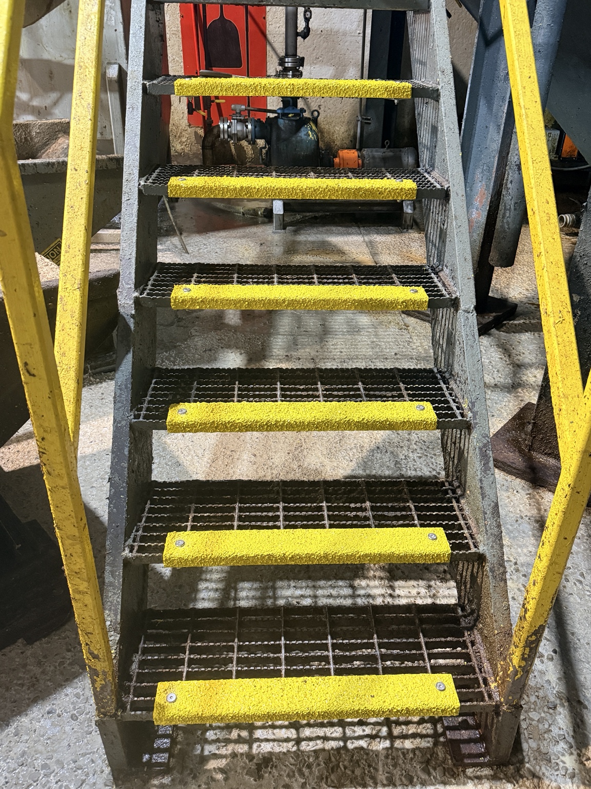 Industrial steel stairs with yellow safety nosings